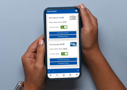 Persons hands holding mobile device displaying EECU's Card Control on screen.